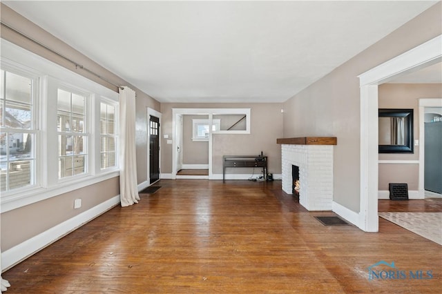 unfurnished living room featuring hardwood / wood-style flooring and a fireplace