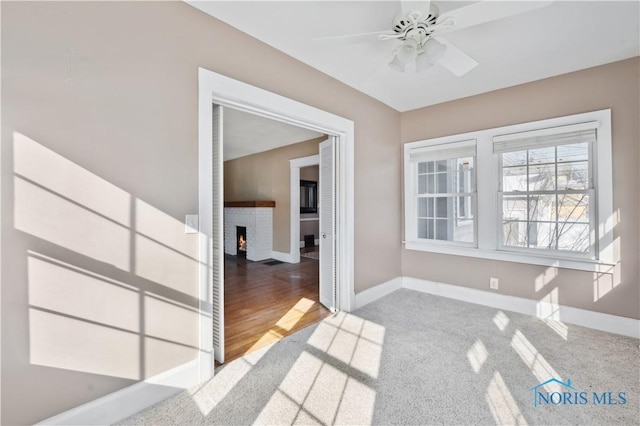 interior space featuring a fireplace and ceiling fan