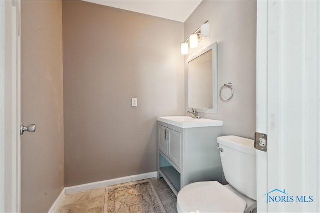 bathroom with vanity, tile patterned floors, and toilet