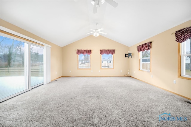 carpeted spare room with vaulted ceiling and ceiling fan