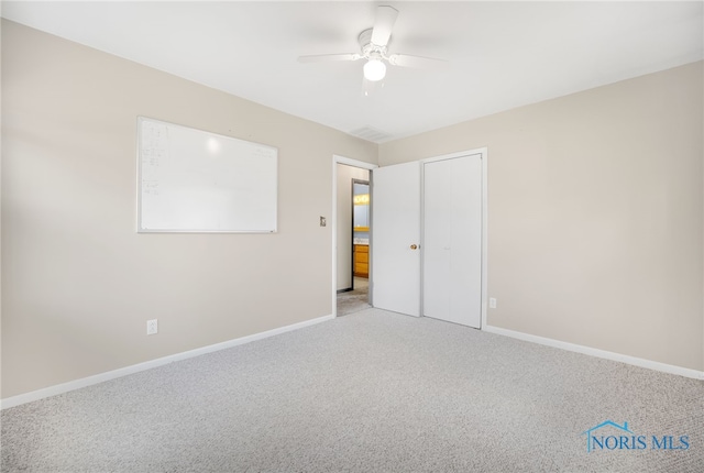 carpeted empty room with ceiling fan