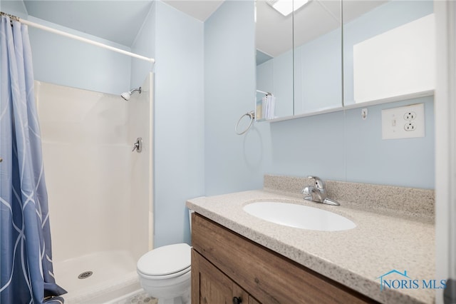 bathroom featuring vanity, curtained shower, and toilet