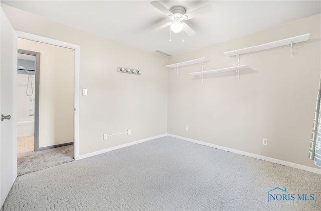 spare room featuring ceiling fan and carpet