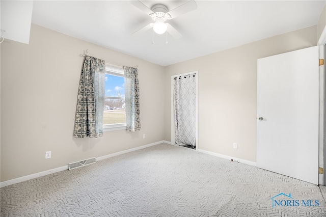 carpeted empty room with ceiling fan