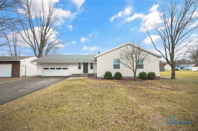 single story home with a garage and a front lawn