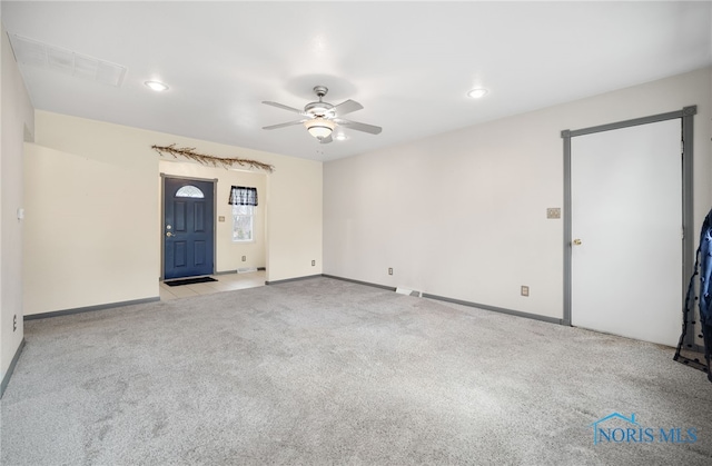 empty room with ceiling fan and light colored carpet