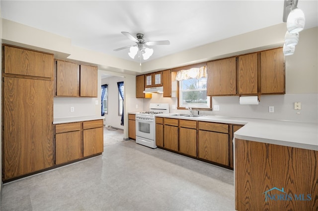 kitchen with ceiling fan, sink, and white gas stove