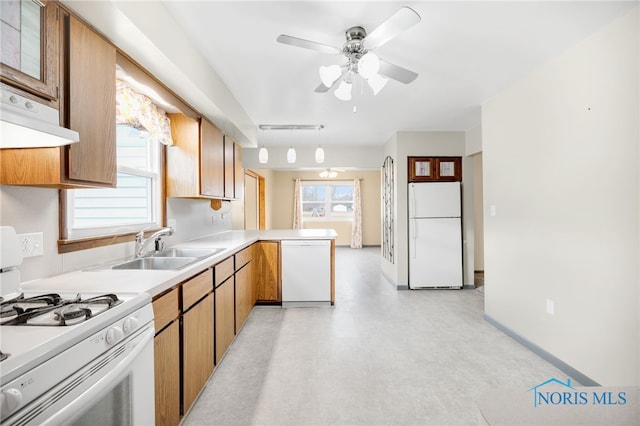 kitchen featuring sink, white appliances, hanging light fixtures, kitchen peninsula, and ceiling fan