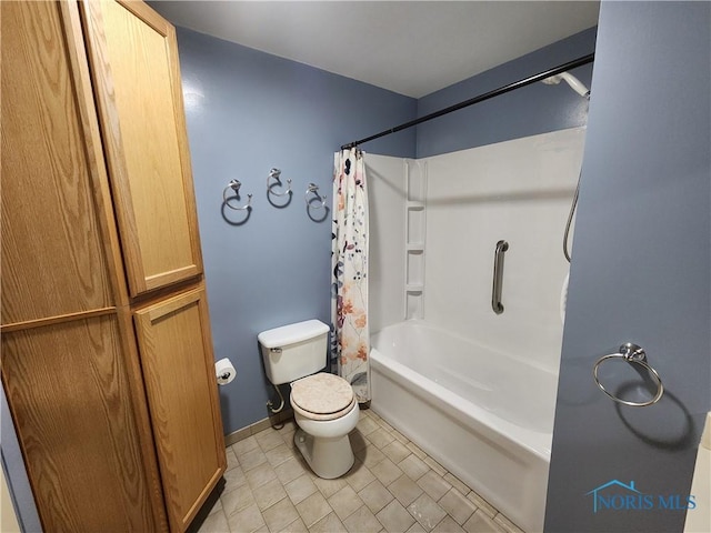 bathroom featuring shower / tub combo with curtain, tile patterned floors, and toilet