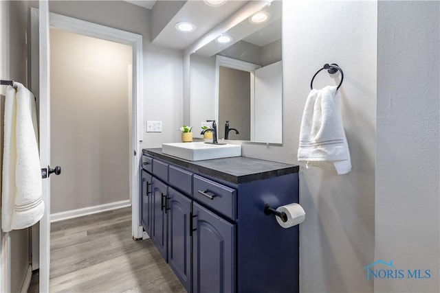 bathroom with vanity and hardwood / wood-style flooring