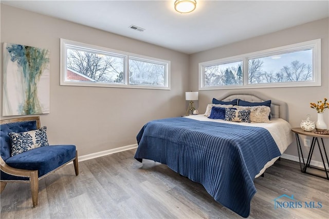 bedroom with wood-type flooring