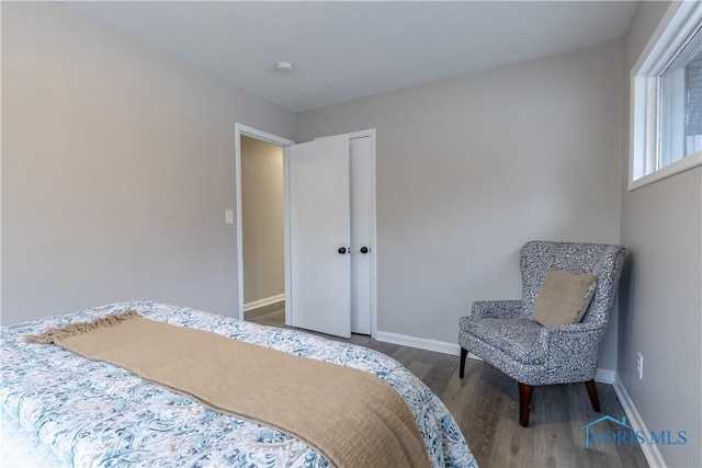 bedroom with dark hardwood / wood-style flooring