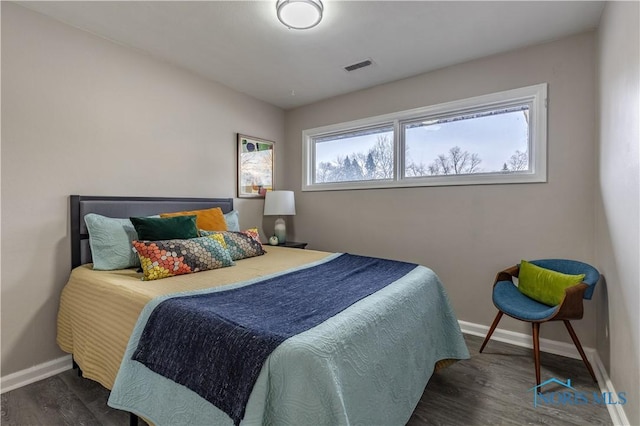 bedroom with dark hardwood / wood-style floors