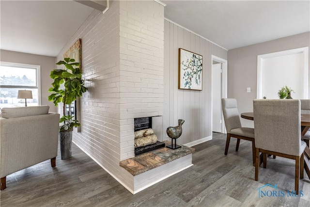 dining space featuring dark hardwood / wood-style flooring and a fireplace