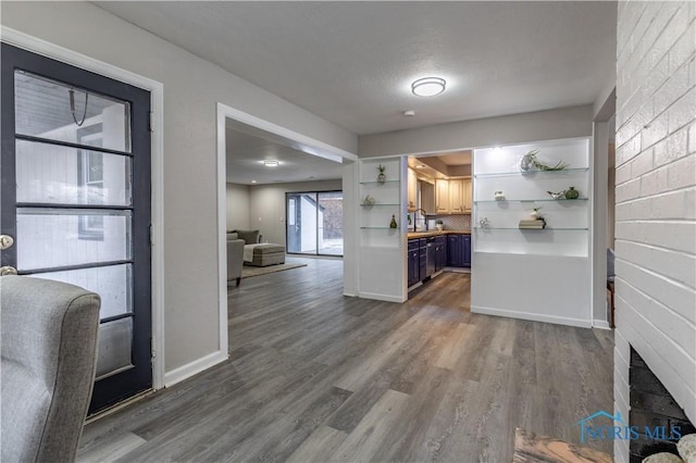 interior space with blue cabinets, dark hardwood / wood-style floors, a fireplace, and wood counters