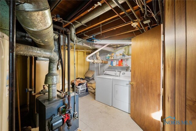 clothes washing area with washing machine and dryer