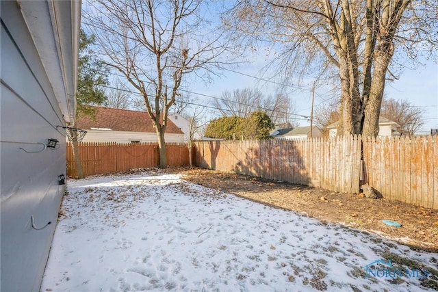 view of yard layered in snow