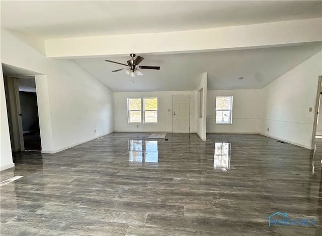 unfurnished living room with dark hardwood / wood-style floors, ceiling fan, a wealth of natural light, and vaulted ceiling with beams