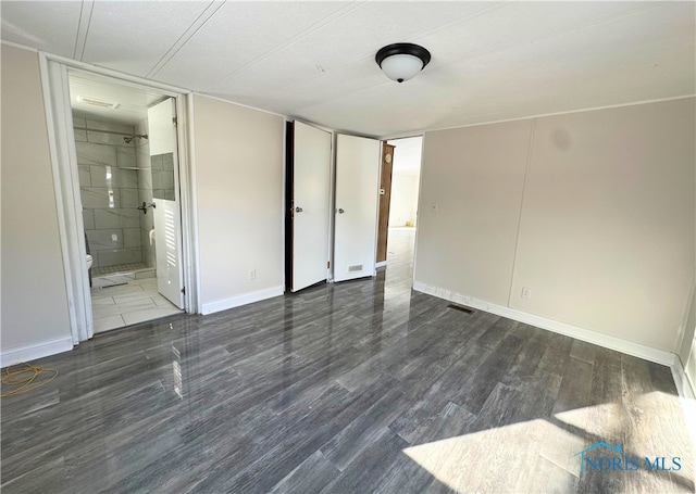 spare room featuring dark hardwood / wood-style floors