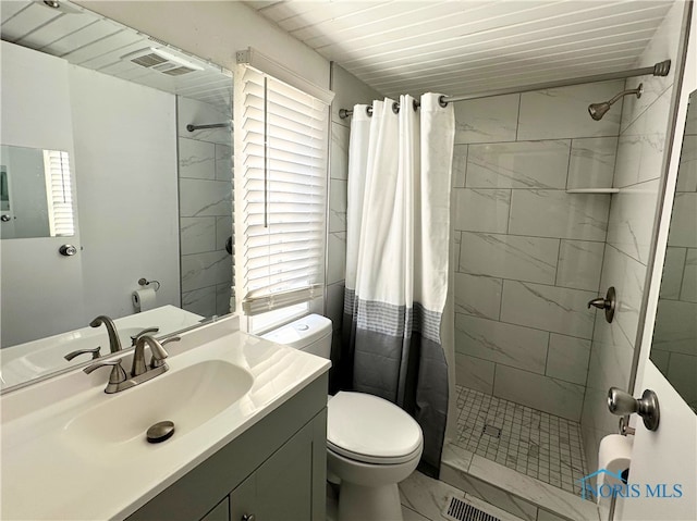 bathroom featuring vanity, toilet, and a shower with curtain