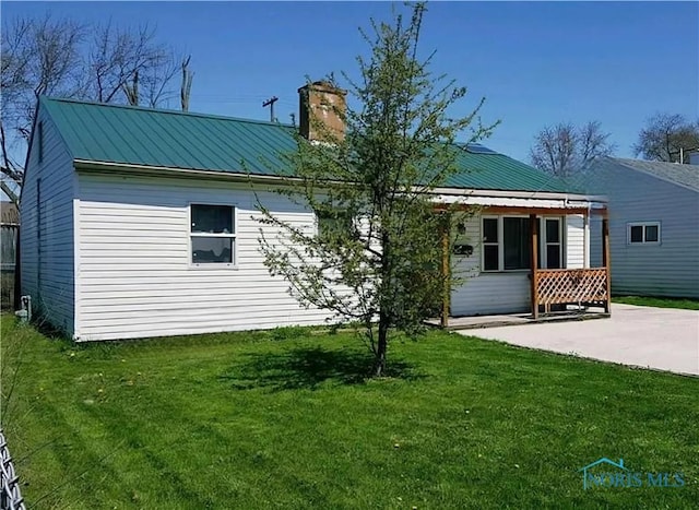 back of property featuring a yard and a patio