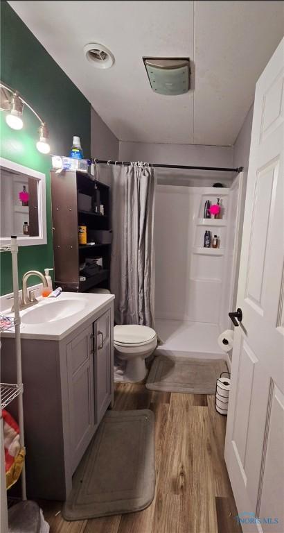 bathroom featuring vanity, curtained shower, and hardwood / wood-style floors