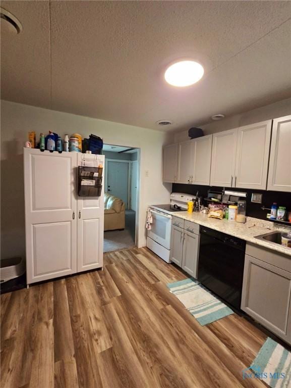 kitchen with sink, white electric range, light hardwood / wood-style floors, and black dishwasher