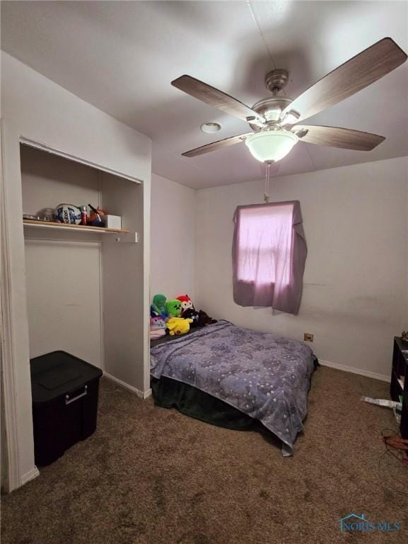 bedroom with dark colored carpet and ceiling fan