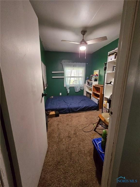 bedroom featuring ceiling fan and carpet