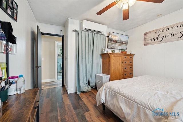 bedroom featuring ceiling fan, dark hardwood / wood-style floors, and an AC wall unit