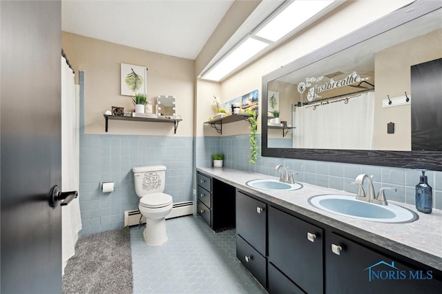 bathroom with vanity, a baseboard heating unit, toilet, and tile walls