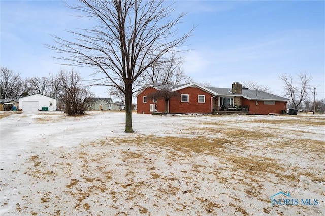 exterior space with a garage and an outbuilding