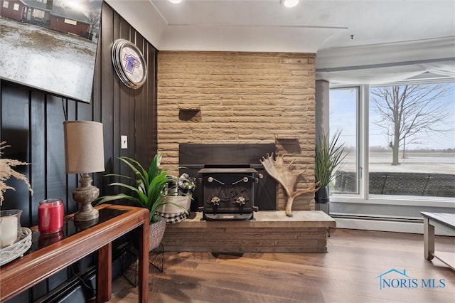 living room featuring hardwood / wood-style flooring and baseboard heating