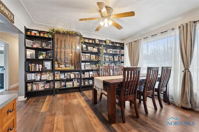 dining space featuring hardwood / wood-style flooring and ceiling fan