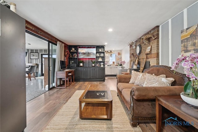 living room featuring a wealth of natural light and wood-type flooring