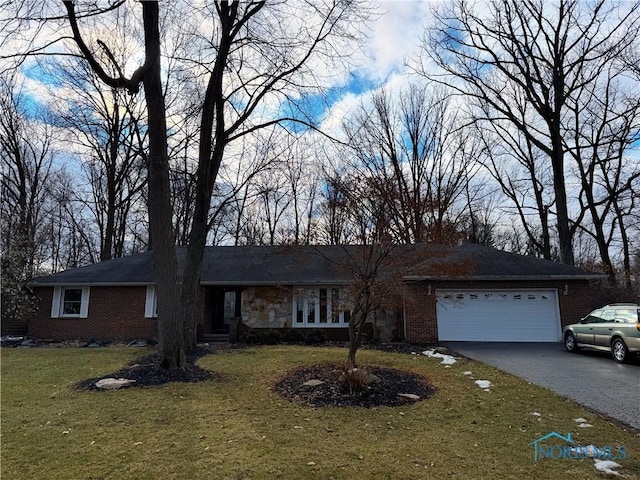 single story home featuring a garage and a front yard