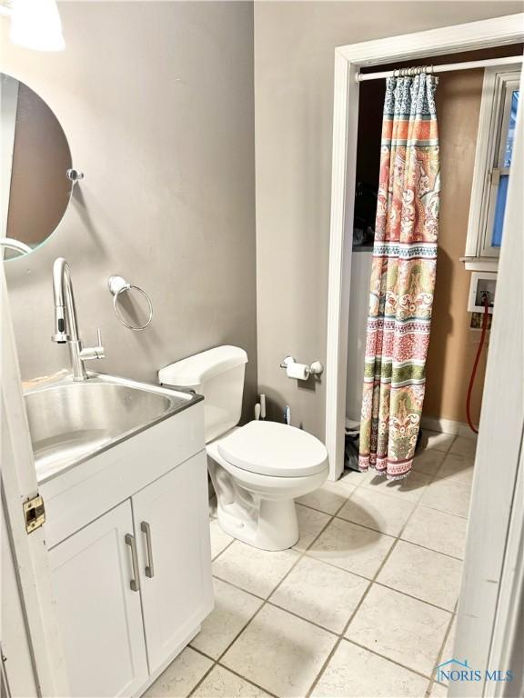 bathroom featuring tile patterned floors, toilet, and vanity