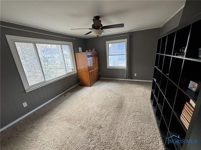 interior space with ceiling fan and carpet floors