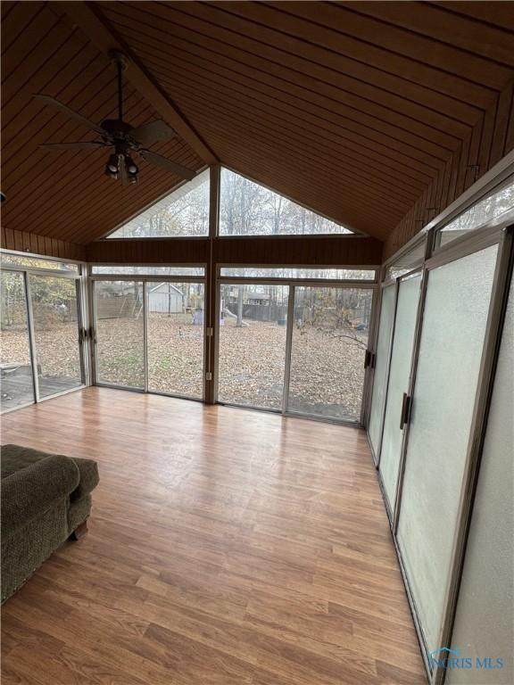 unfurnished sunroom with vaulted ceiling and ceiling fan