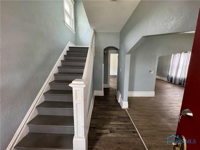 stairs featuring hardwood / wood-style flooring