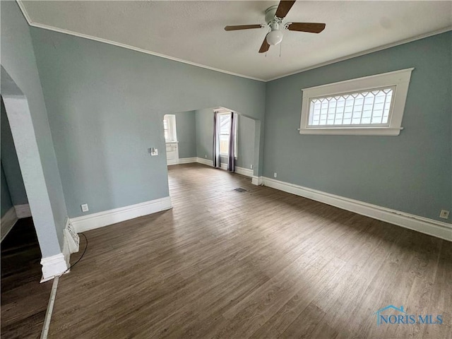 spare room featuring crown molding, ceiling fan, and dark hardwood / wood-style flooring