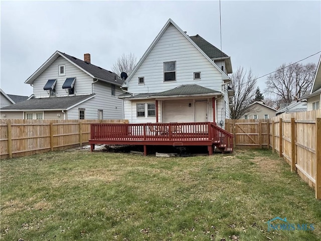 back of house with a yard and a deck