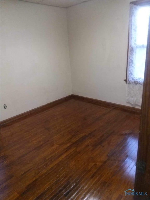 spare room featuring dark hardwood / wood-style floors