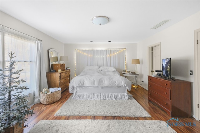 bedroom with dark wood-type flooring