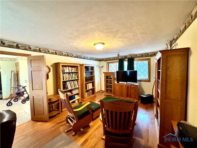 living area featuring hardwood / wood-style flooring and a textured ceiling