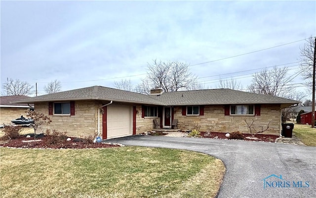 single story home with a garage and a front lawn