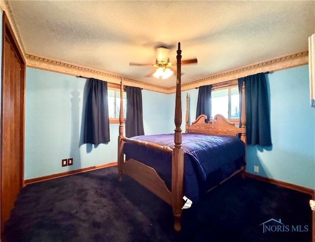 carpeted bedroom featuring ceiling fan and a textured ceiling