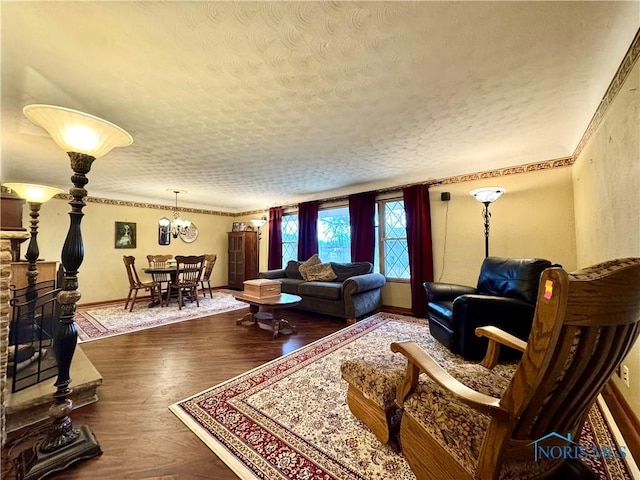 living room with a stone fireplace, hardwood / wood-style floors, and a textured ceiling