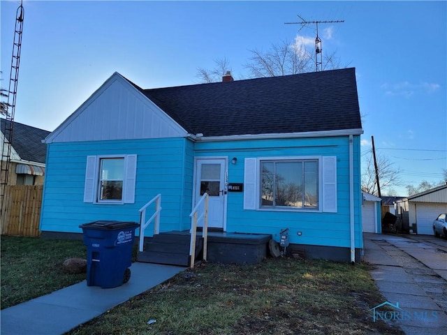 view of front facade with an outbuilding and a garage