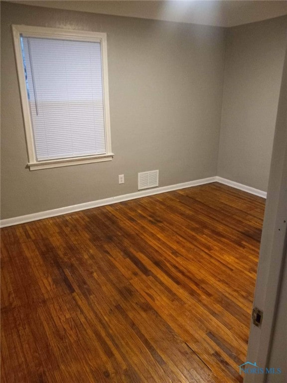 spare room featuring dark hardwood / wood-style floors